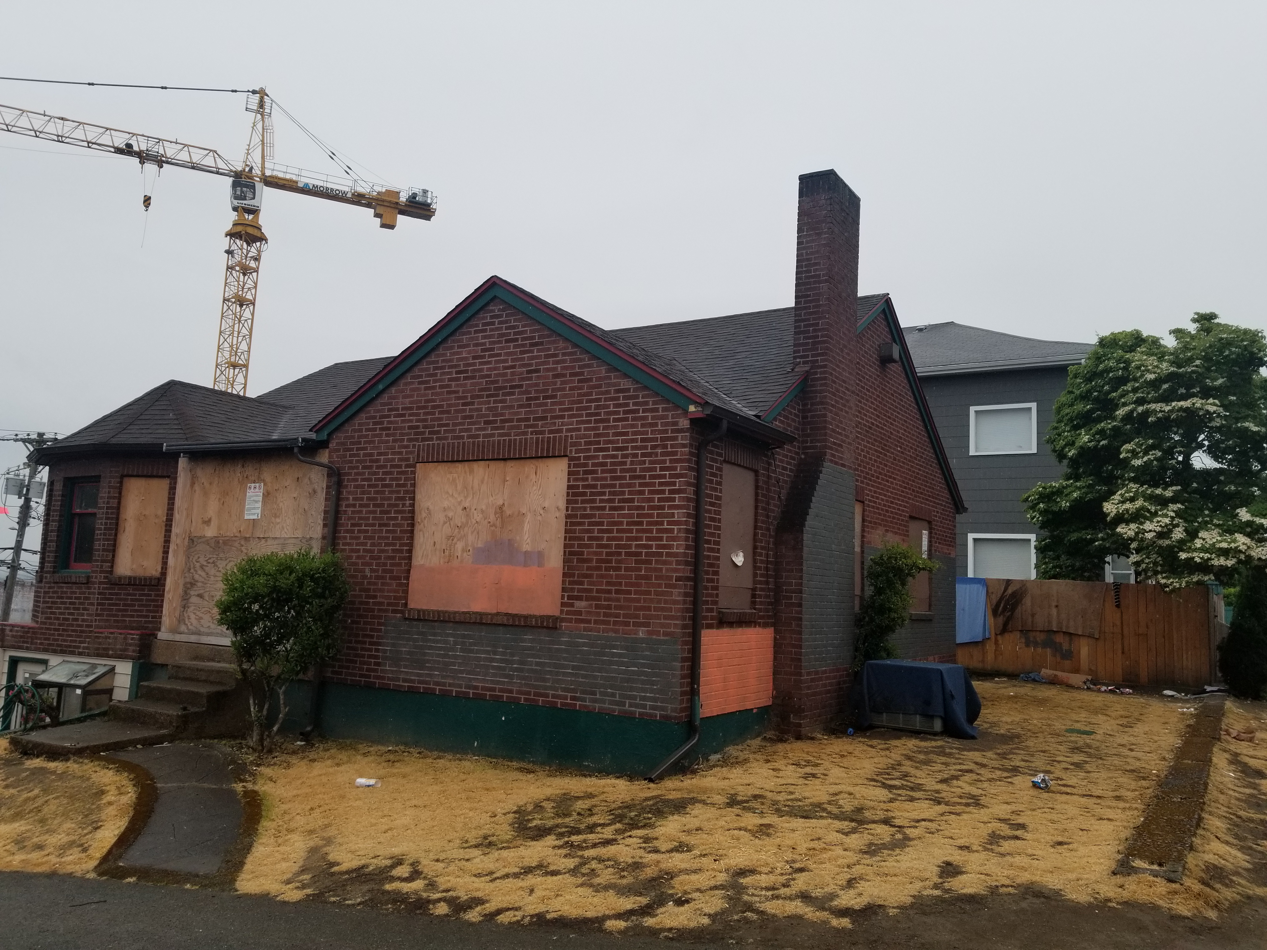 Trap house example — boarded brick bungalow
