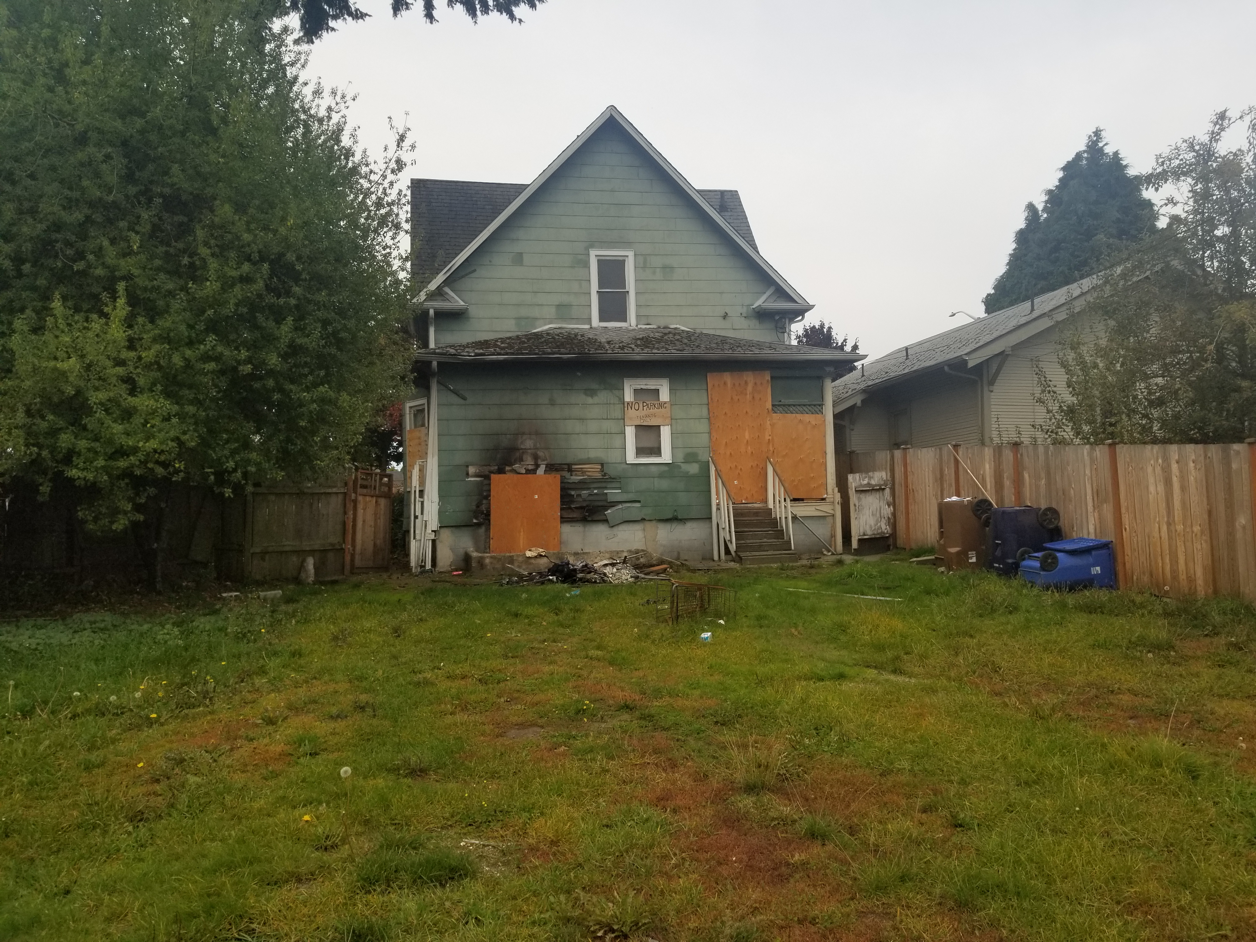 Distressed house example — fire damage and boarded doors